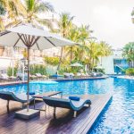 Umbrella pool and chair around beautiful luxury swimming pool in hotel resort - Vintage Light film Filter